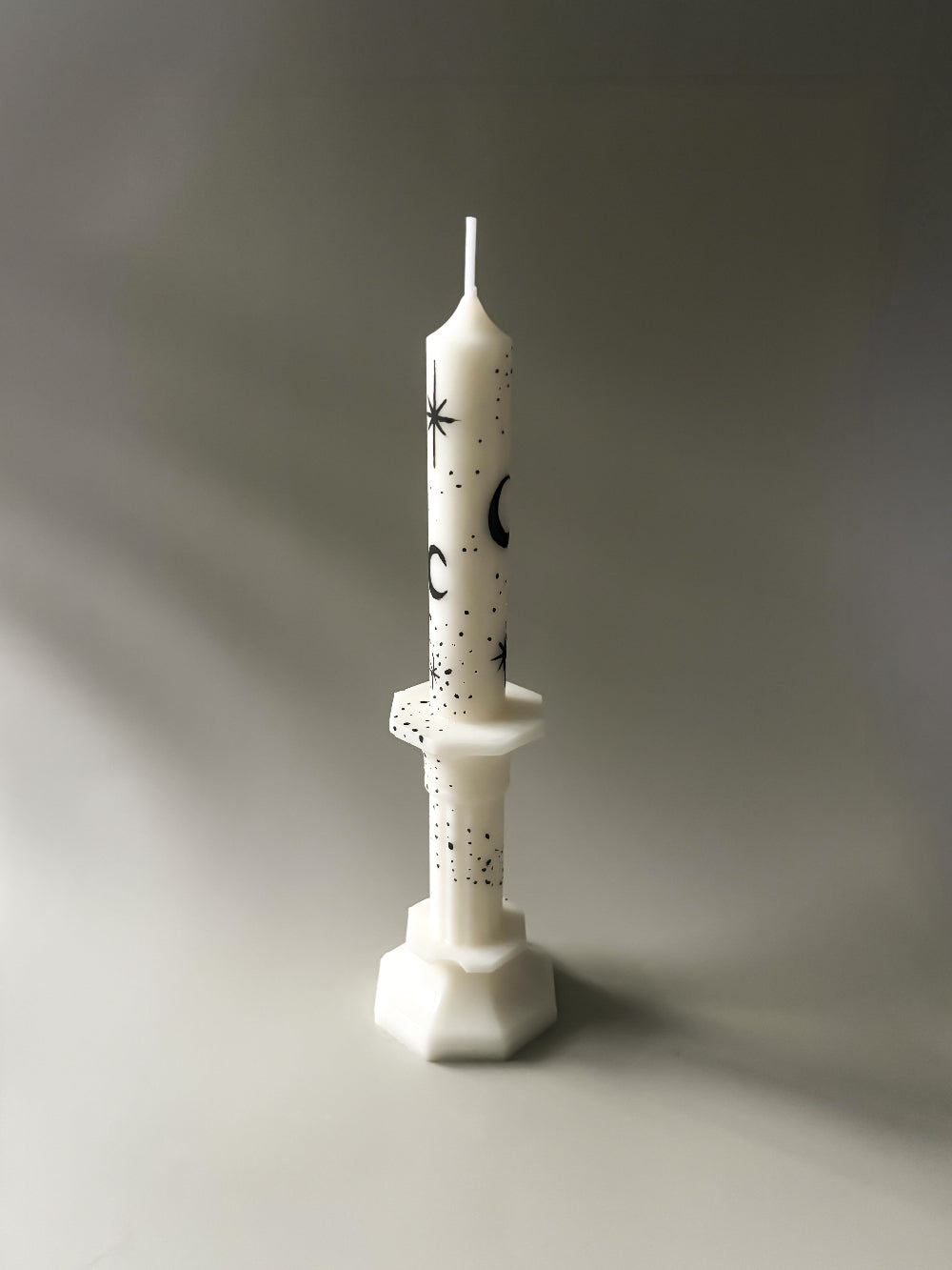 White taper candle with black hand painted moon and stars