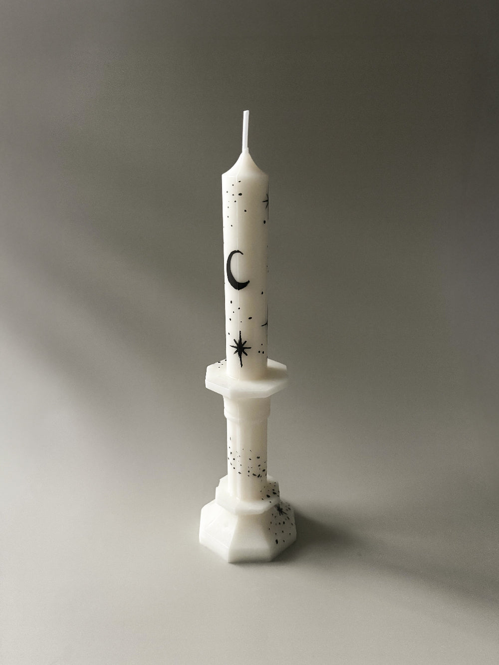 White taper candle with black hand painted moon and stars